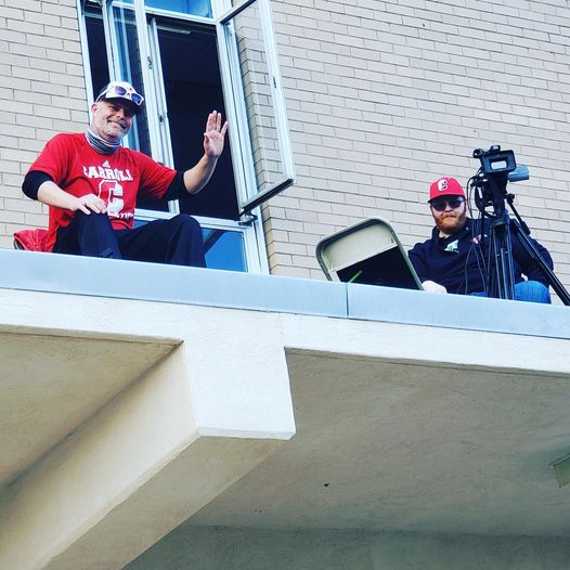 Mr. Ed Scanlan is high on the rooftop to announce a girls soccer game while Mr. Devin Gallagher handles the camera and the livestreaming. 