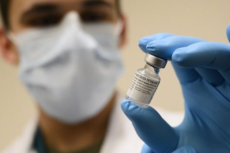 Army Spc. Angel Laureano holds a vial of the COVID-19 vaccine, Walter Reed National Military Medical Center, Bethesda, Md., Dec. 14, 2020. (DoD photo by Lisa Ferdinando)