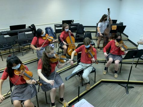 The String Ensemble works hard to perfect its performance.