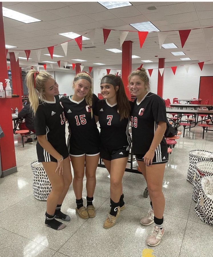 Seniors Reagan Duzy (far left), Amanda Armstrong (second from right), and Emma Talago (fra right) celebrate Senior Night and victories over rival OHara with junior Ella Wright (second from left).
