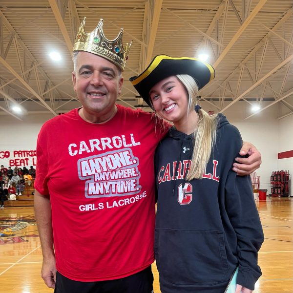 The just-crowned faculty homecoming king, Mr. Louis Valenti, hangs out at the homecoming pep rally with senior Maryrita Swope.