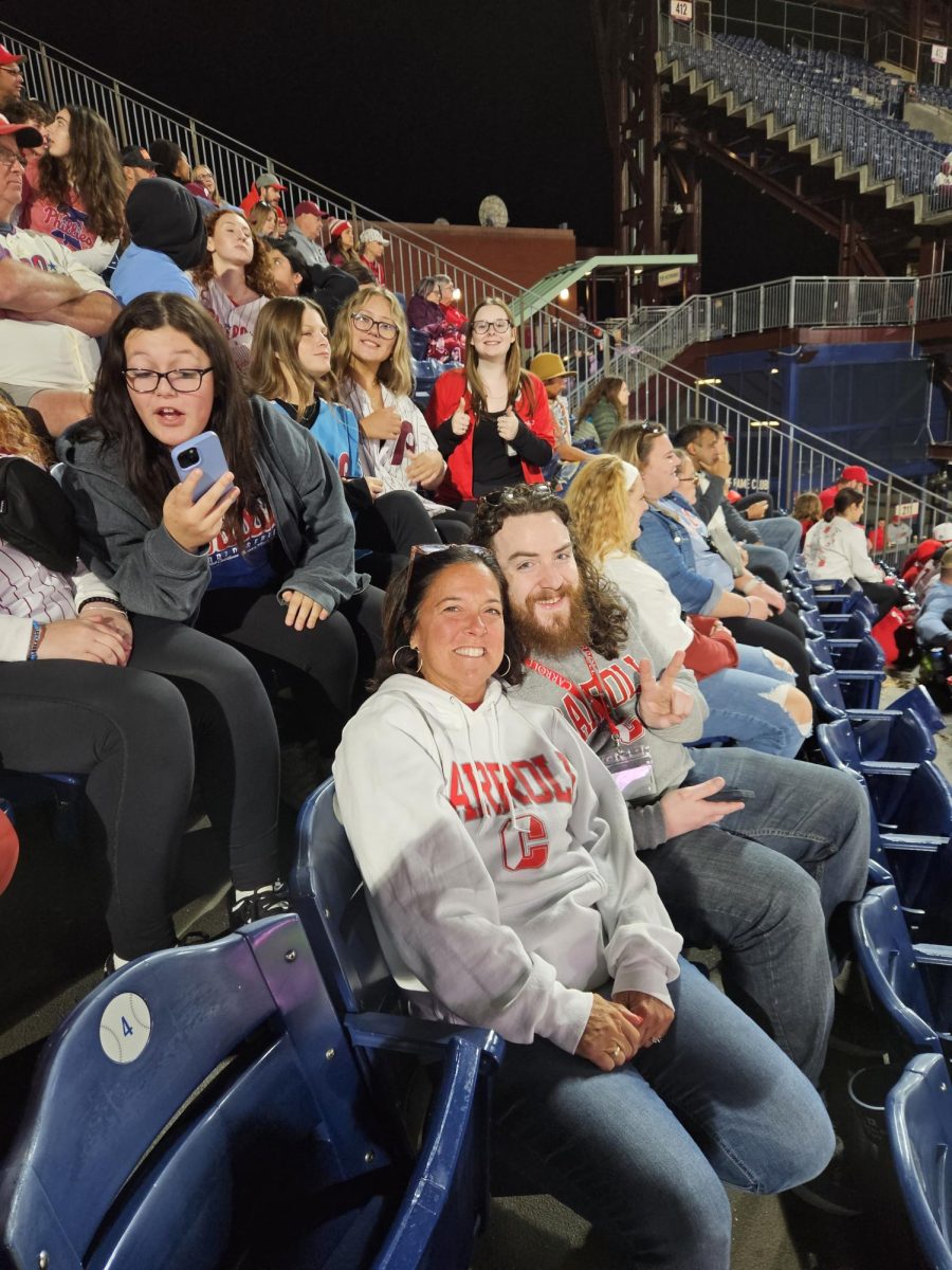 Mr. Eric Tamney, Carrolls new campus minister, enjoys a Phillies game with students and school president Dr. Patricia Scott