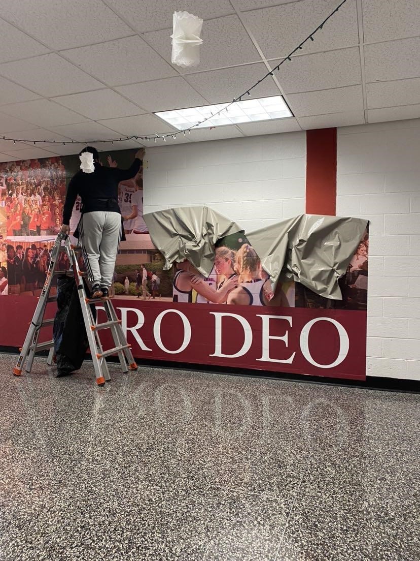 Archbishop Carrolls original branding mural near the main office comes down in preparation for the installation of a reimagined one. 