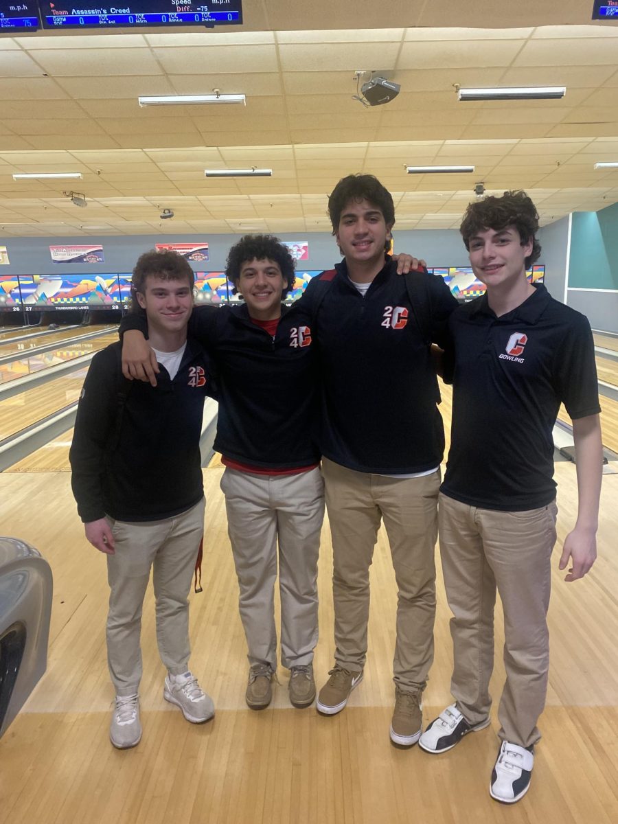 Seniors Jesse Ventre, Marco Petroccia, Stephen Thomson and James Klusarits show some brotherly love during their last bowling match of the season.